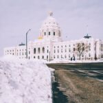 Snow-lined road leading to the Minnesota State Capitol in Saint Paul, showcasing the frigdet beauty of a Twin Cities winter evening.